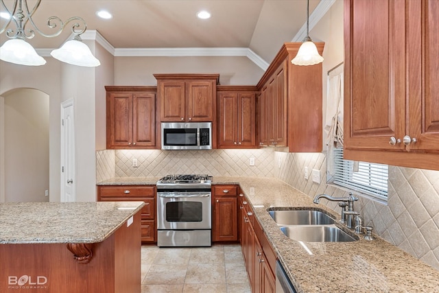 kitchen featuring sink, decorative light fixtures, ornamental molding, and appliances with stainless steel finishes