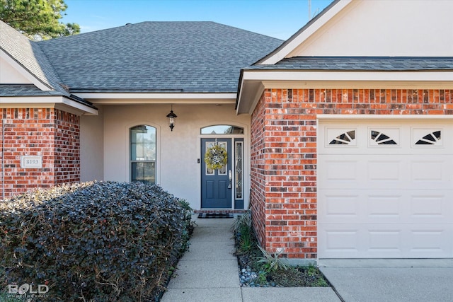 view of exterior entry with a garage