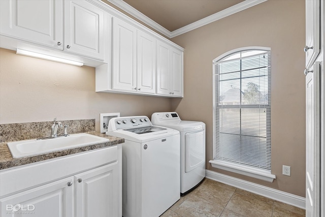 washroom featuring sink, crown molding, light tile patterned floors, cabinets, and washer and dryer