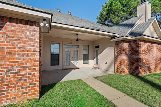 doorway to property with french doors, ceiling fan, a yard, and a patio