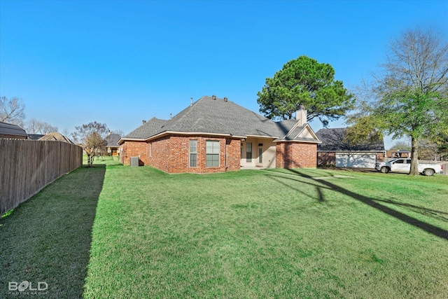 rear view of house with a lawn