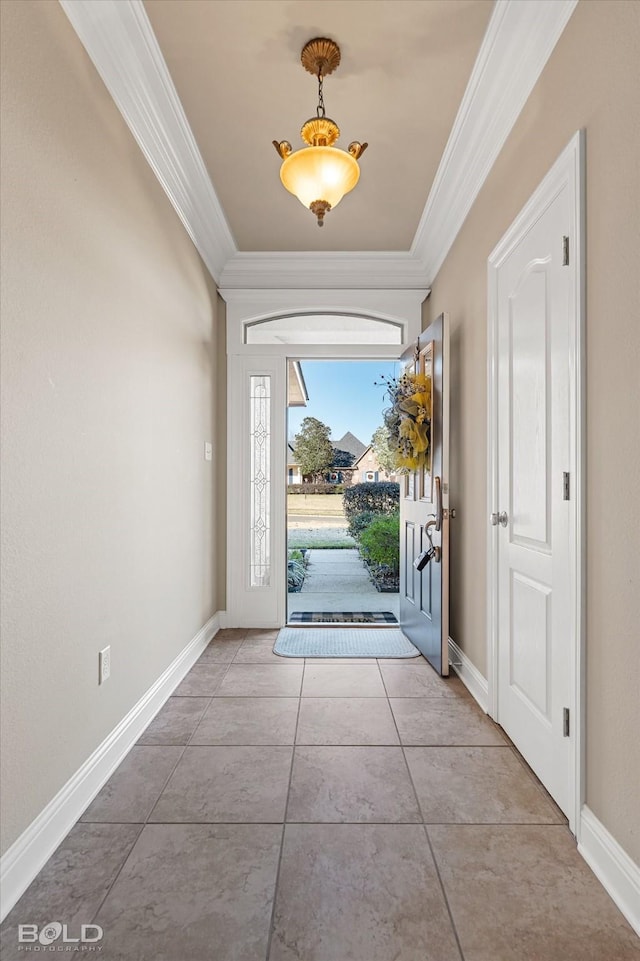 foyer with crown molding and tile patterned floors