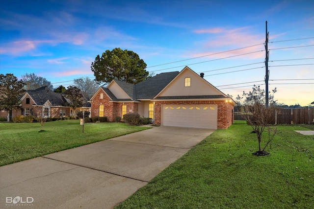 view of front of property featuring a garage and a lawn