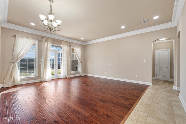 interior space featuring a notable chandelier, ornamental molding, light hardwood / wood-style floors, and french doors