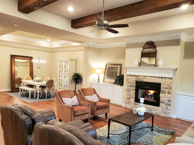 living room featuring beamed ceiling, light hardwood / wood-style floors, and a tray ceiling