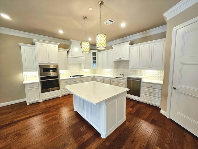 kitchen featuring stainless steel appliances, light stone countertops, custom range hood, and white cabinets