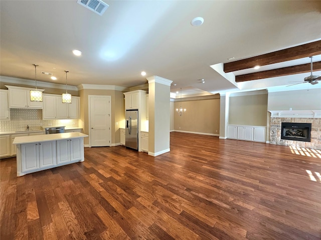 kitchen featuring ceiling fan with notable chandelier, white cabinetry, hanging light fixtures, a center island, and stainless steel appliances