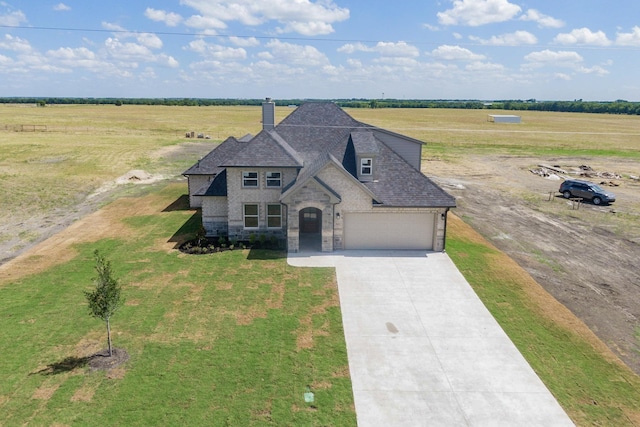 view of front of house featuring a rural view and a front lawn