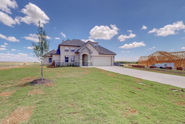 view of front of home featuring a front lawn, stone siding, concrete driveway, an attached garage, and brick siding