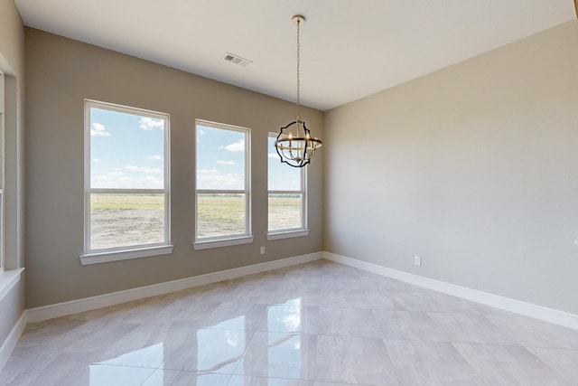 spare room featuring visible vents, baseboards, and a notable chandelier