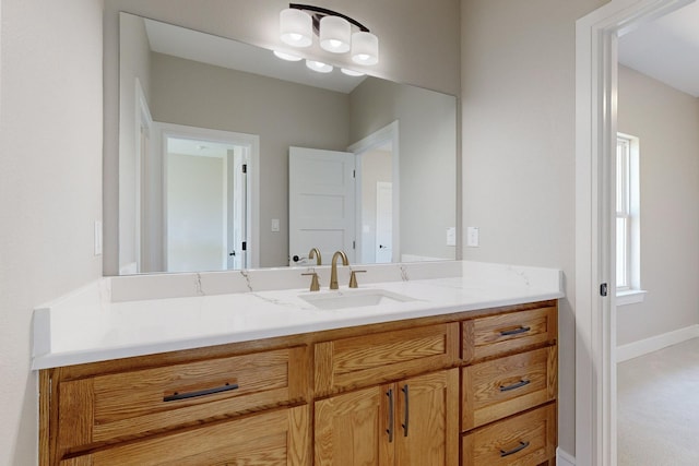 bathroom with vanity and baseboards