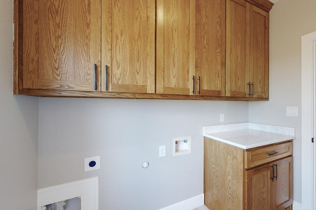 laundry area with electric dryer hookup, cabinet space, gas dryer hookup, and washer hookup