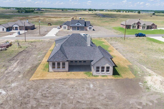 birds eye view of property with a rural view