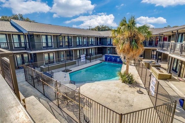 view of pool with a patio and pool water feature