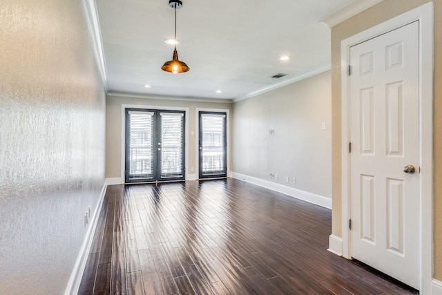 unfurnished room with ornamental molding, dark wood-type flooring, and french doors