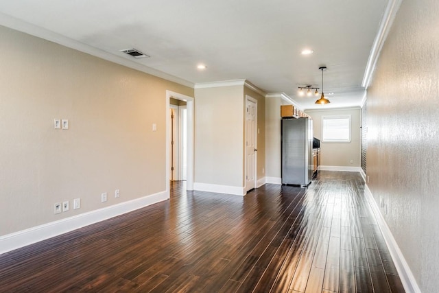 spare room with dark hardwood / wood-style flooring and ornamental molding