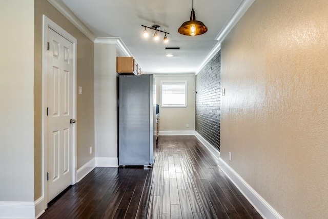 hall with dark wood-type flooring and ornamental molding