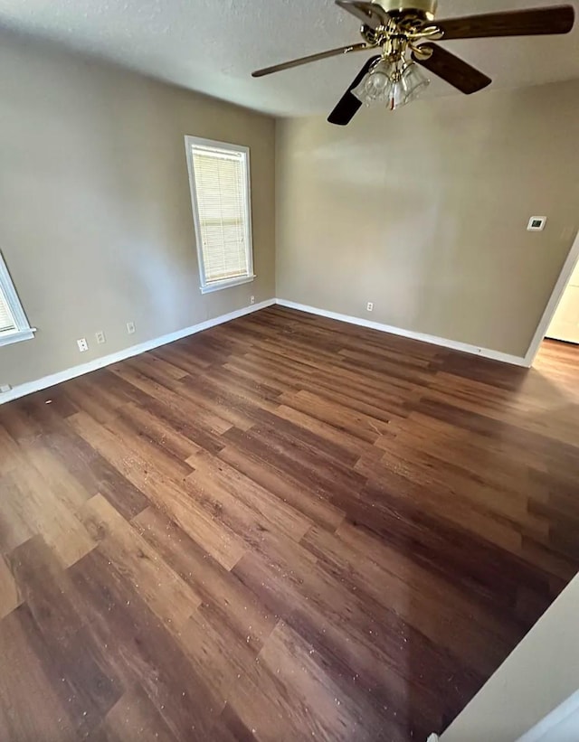 empty room with hardwood / wood-style floors and ceiling fan