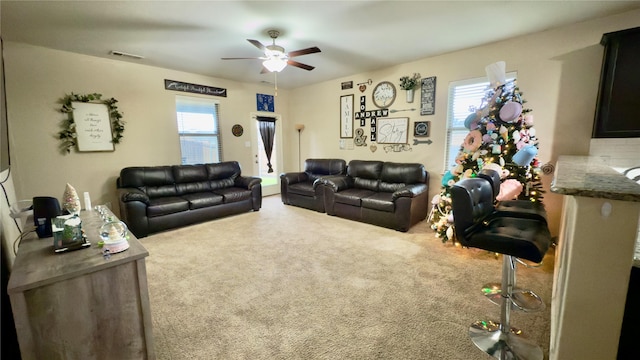 living room featuring ceiling fan and carpet