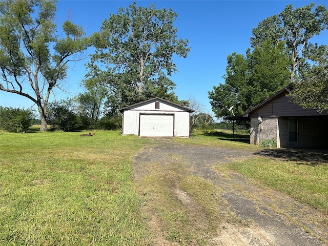 view of yard with a garage and an outdoor structure