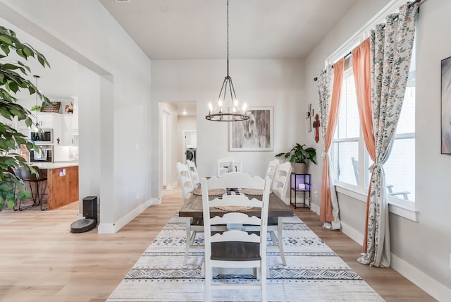 dining room featuring a chandelier and light hardwood / wood-style floors