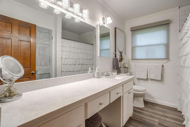 bathroom with vanity, hardwood / wood-style flooring, toilet, and ornamental molding