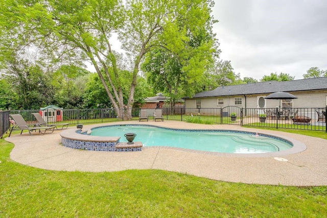 view of pool with a patio area and a lawn