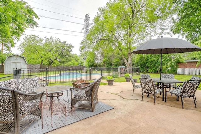 view of patio featuring a storage shed and a fenced in pool