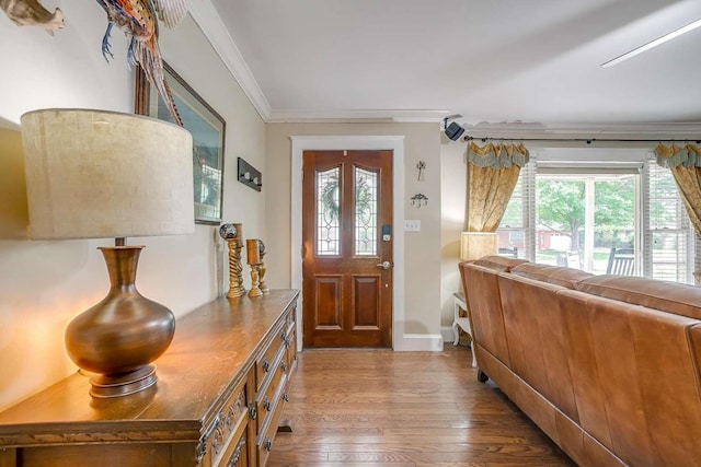 entrance foyer with hardwood / wood-style flooring and crown molding