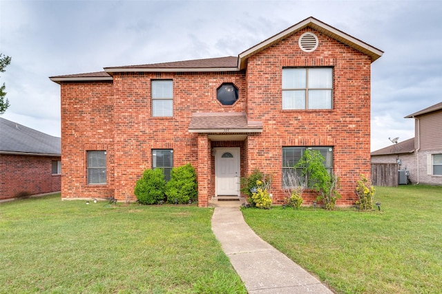 view of front property featuring central AC and a front lawn