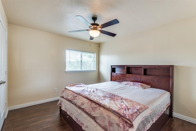 bedroom with ceiling fan and dark wood-type flooring