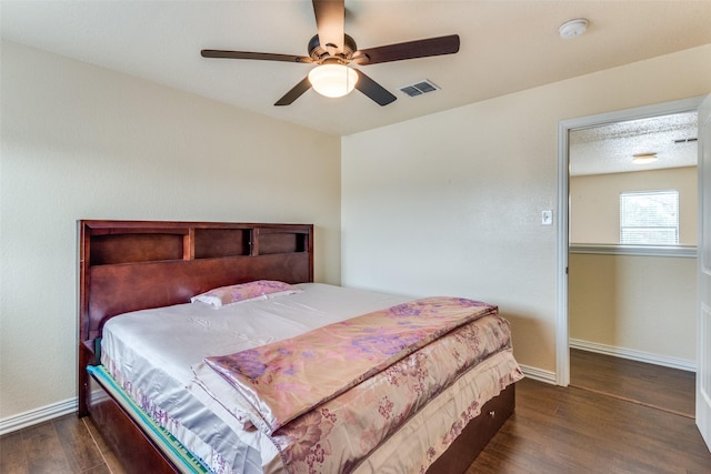 bedroom with ceiling fan and dark wood-type flooring