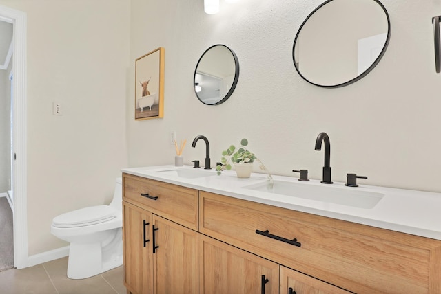 bathroom with tile patterned flooring, vanity, and toilet