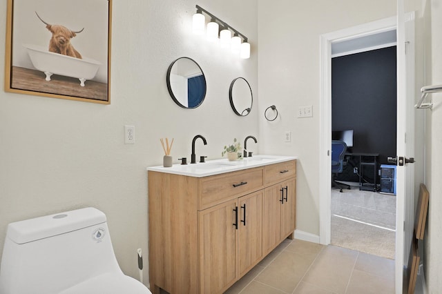 bathroom with tile patterned flooring, vanity, and toilet