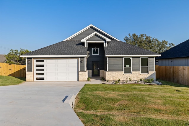 view of front of home featuring a front lawn and a garage