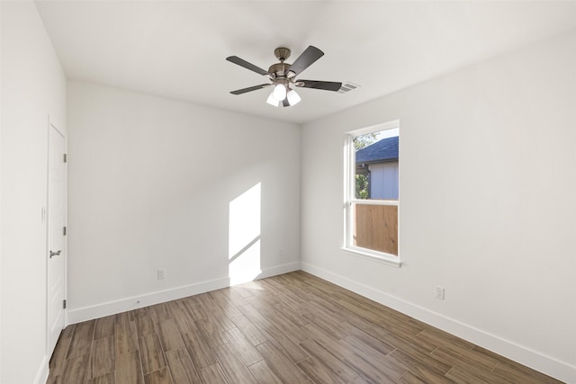 spare room with hardwood / wood-style floors and ceiling fan