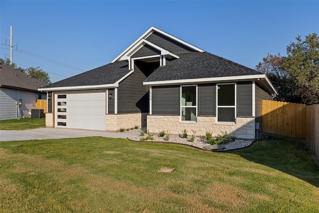 view of front facade featuring central AC unit, a garage, and a front yard