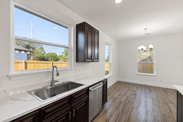 kitchen with dishwasher, sink, light hardwood / wood-style floors, a chandelier, and pendant lighting