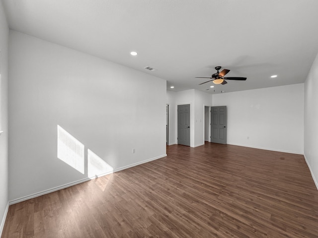 unfurnished room featuring ceiling fan and dark hardwood / wood-style flooring