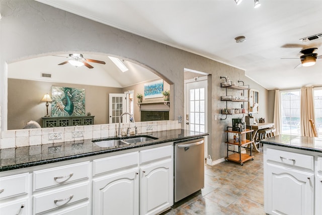 kitchen featuring lofted ceiling, sink, white cabinetry, dishwasher, and ceiling fan