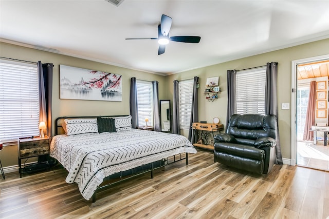 bedroom with ceiling fan, ornamental molding, and hardwood / wood-style floors