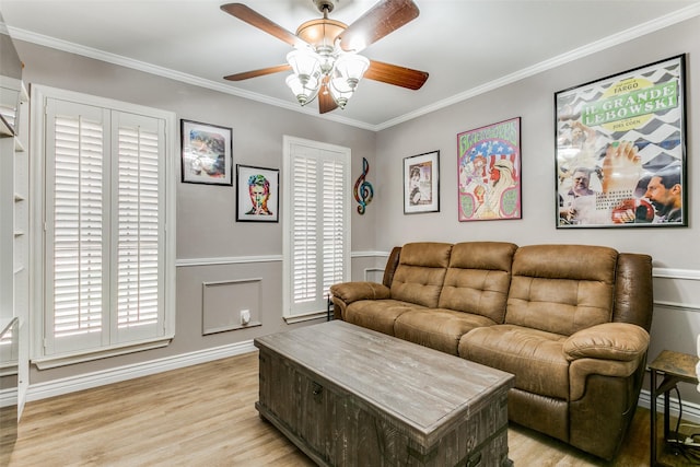 living room with crown molding, ceiling fan, and light wood-type flooring