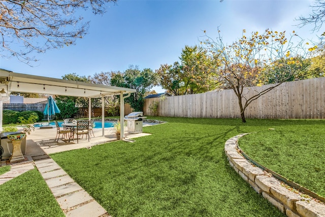 view of yard featuring a fenced in pool and a patio area