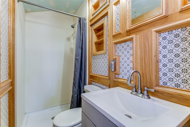 bathroom with vanity, toilet, and curtained shower