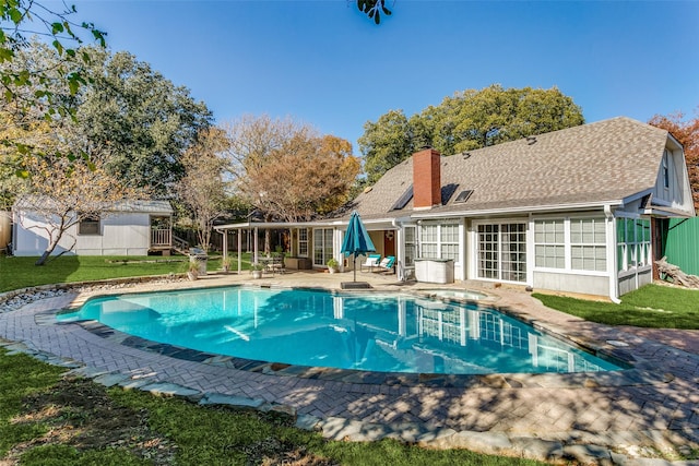 view of swimming pool with a hot tub and a patio