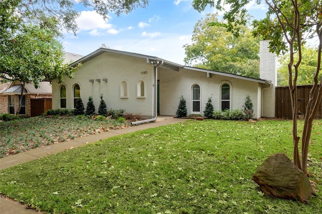 ranch-style home with a front lawn