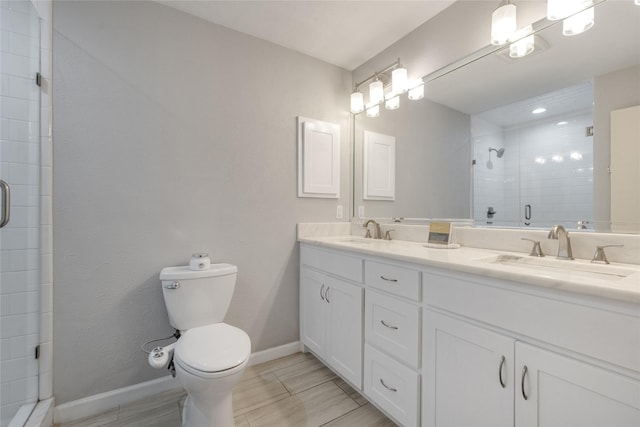 bathroom featuring vanity, an enclosed shower, and toilet