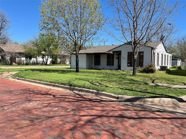 single story home featuring central AC unit and a front lawn