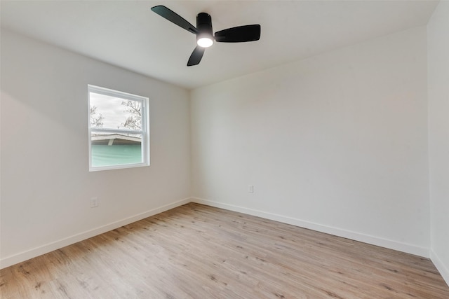 empty room with ceiling fan and light hardwood / wood-style floors