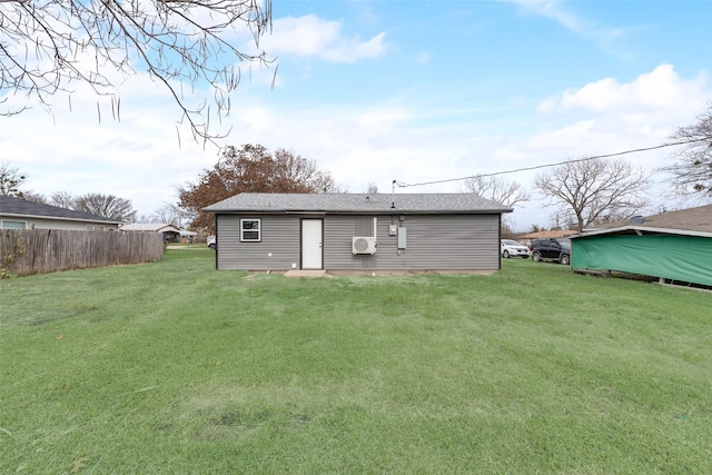 rear view of property with a lawn